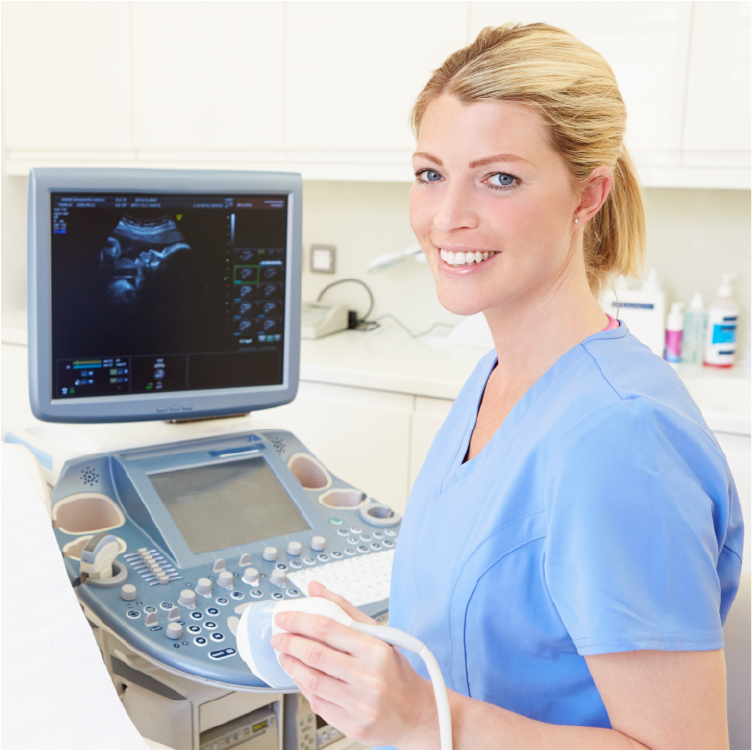 An Ultrasound Tech holding an Ultrasound device with a monitor behind her