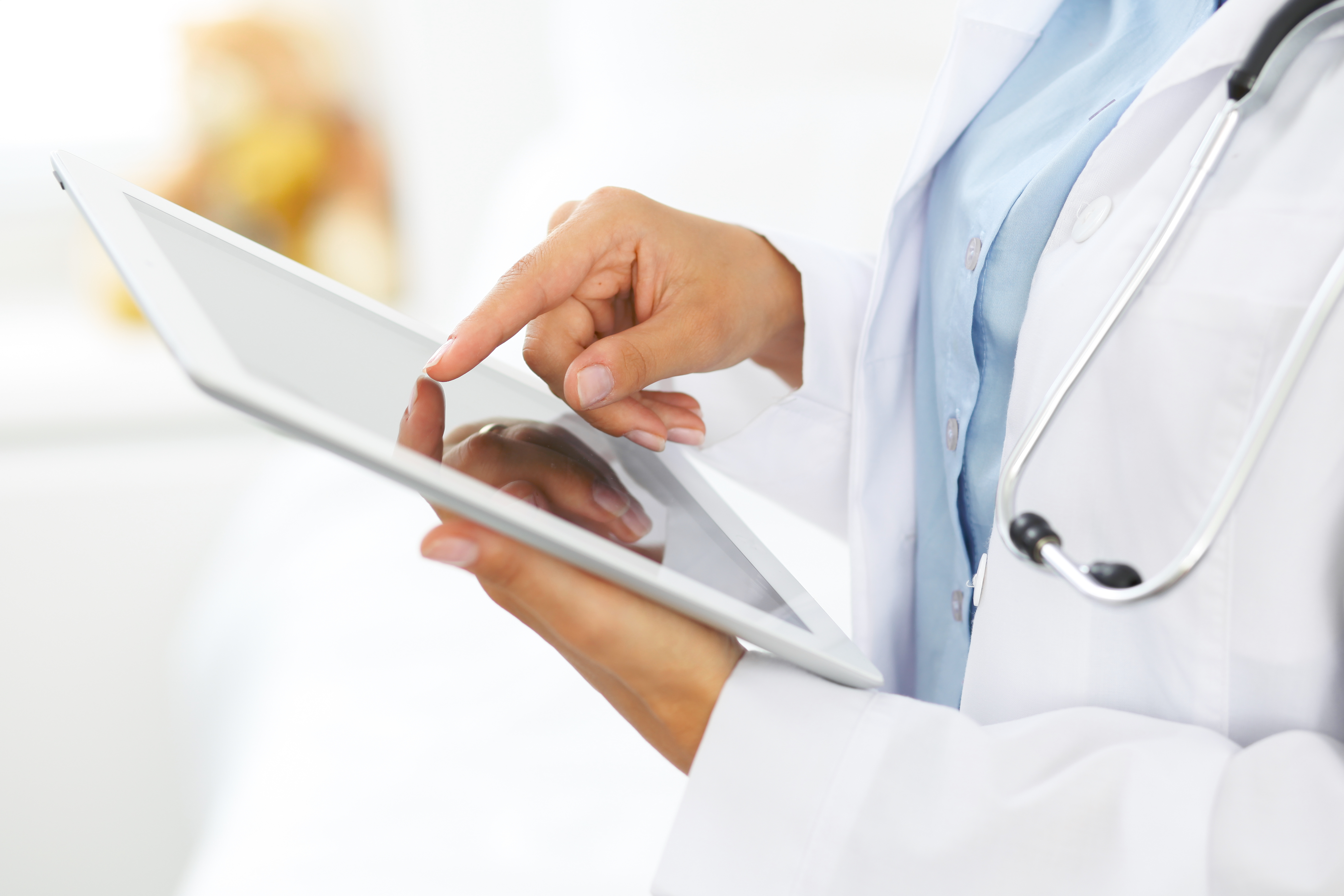 A Lab tech using a tablet to fill out a digital form.
